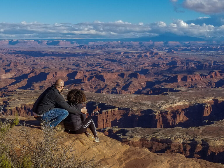 Rocio and Gabe taking in the expansive view of Canyonlands National Park from Island In the Sky District