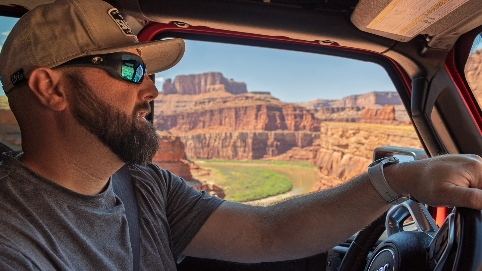 Gabe driving a jeep Wrangler through Moabs red rugged terrain