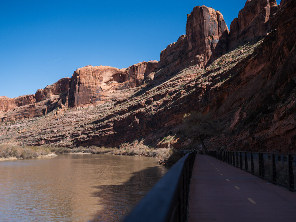 boardwalk and bike path with Red rock cliffs at the Colorado Riverside Recreation area in Moab Utah